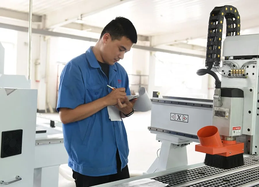 Quick CNC technician carrying out machine inspection