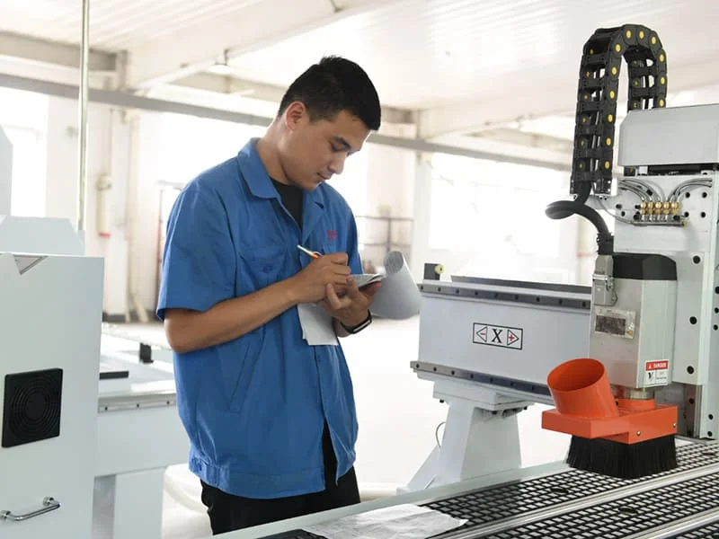 Quick CNC technician checking machine condition in the factory